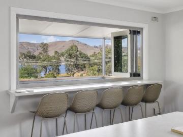 5 bedrooms plus a big boat shed, lined studio and lake views!