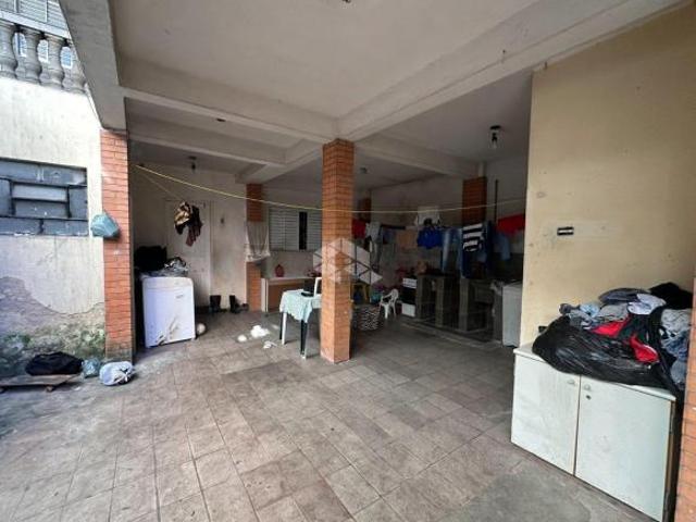 terreno com 5 casas e um salão comercial á venda por R$ 550.000,00