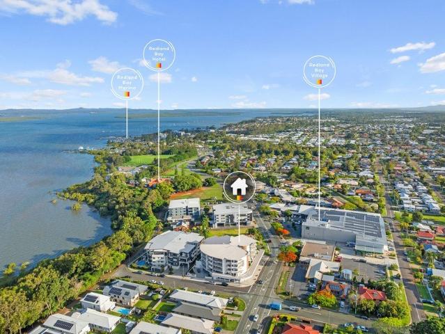 TOP FLOOR BAYSIDE LIVING WITH TWO BALCONIES & WATER GLIMPSES