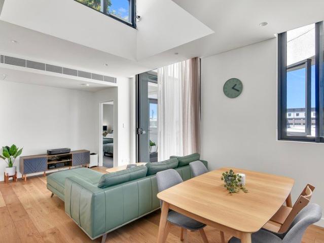 Top Floor Living with Soaring Ceilings, Natural Light & District Views