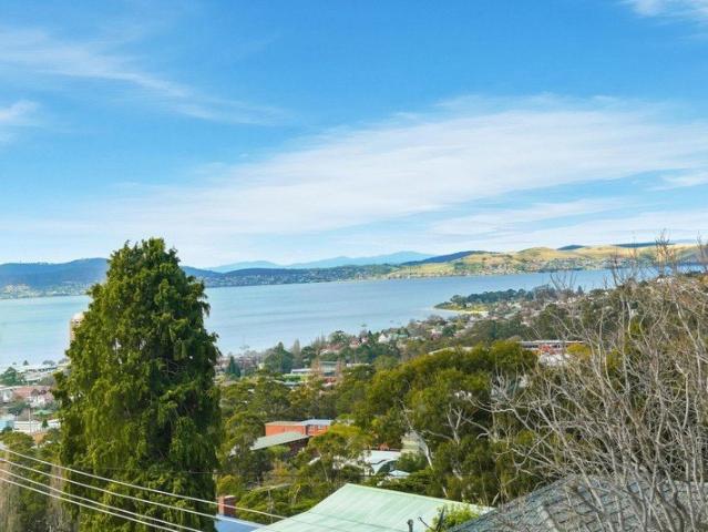 Top floor two bedroom apartment with sweeping water views, generous living and minutes to Hobart CBD