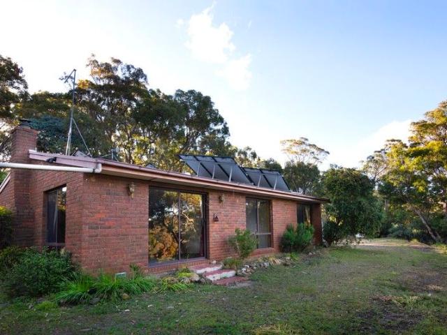 Tranquil 1980s Brick Home in Serene Bush land Setting 11.5 Acres Off Grid Living