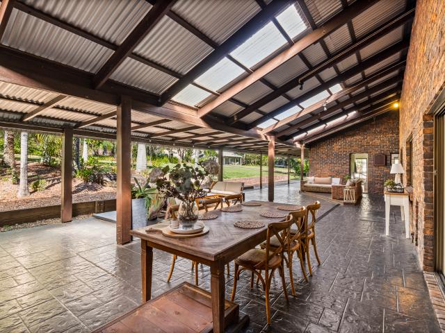 Tranquil Acreage Paradise with Triple Living Amenities