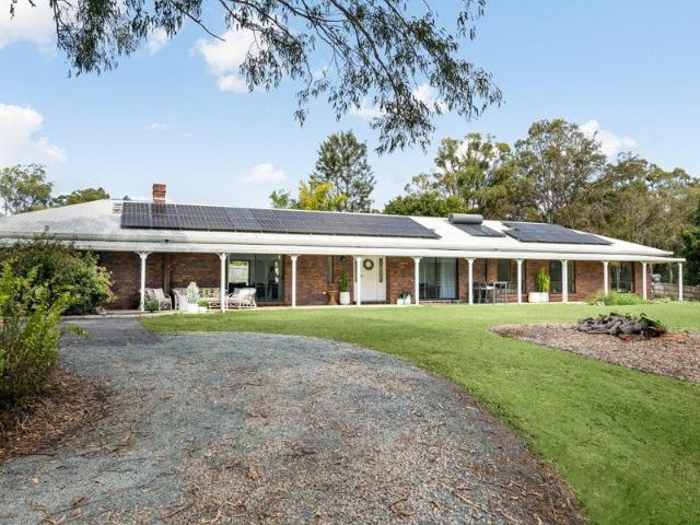 Tranquil Acreage Retreat with Dual Master Suites