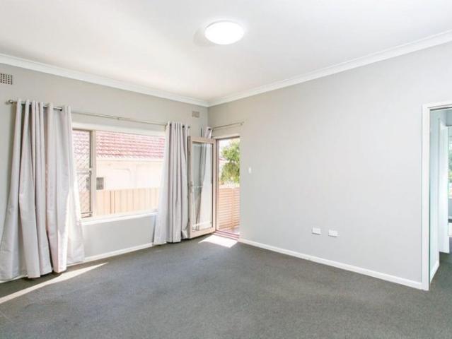 Two bedroom unit with private courtyard and parking