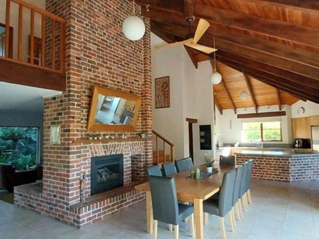 Unique double story brick home on 4 Acres in the middle of town. imaculate gardens and olive grove