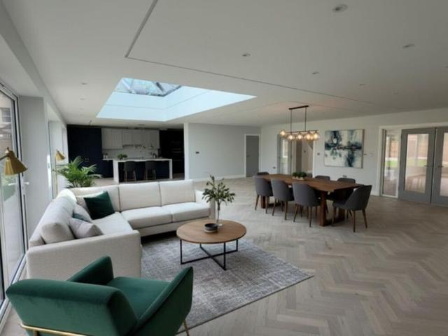 A modern five bedroom, four bathroom detached home featuring generous driveway and a garage