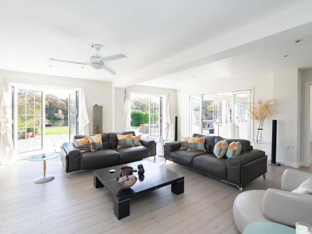 A newly completed contemporary family home enjoying an exceptional lakeside position on the sought after Cobham and Oxshott border.