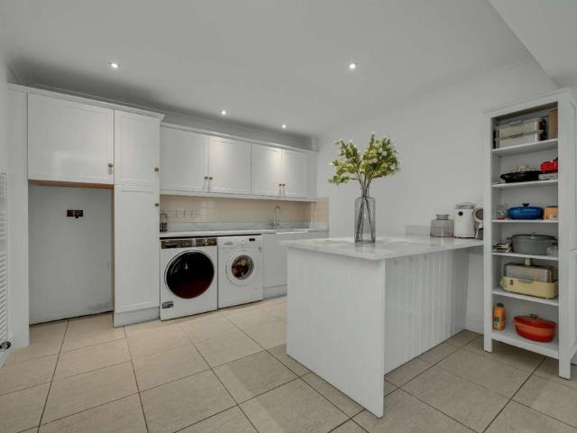 A beautifully presented four bedroom townhouse arranged over four floors, offering spacious living accommodation, a private garden, and an integral garage