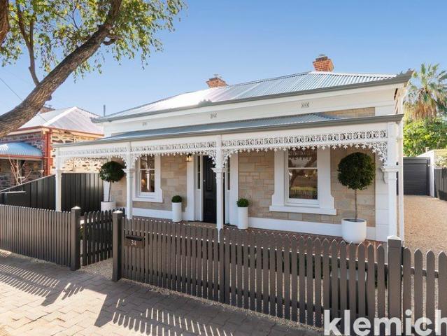 A beautifully restored c.1880 sandstone cottage with north facing modern living, blending character, location, and lock up and leave convenience