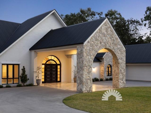A celebration of architectural excellence, where a monumental stone arch sets the tone for unparalleled luxury