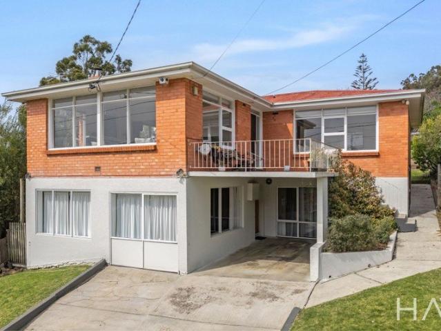 A distinctive 1960s home with modern style, versatile living and an elevated outlook