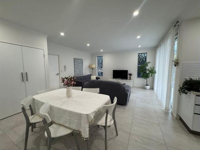A fully furnished two bedroom apartment with a large balcony and a yard