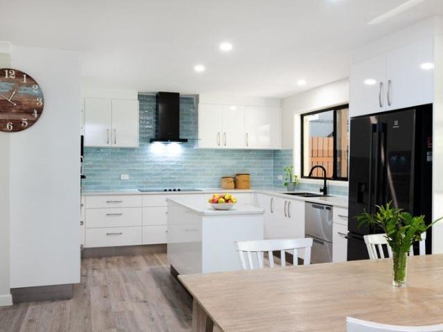 Beautifully Reimagined Coastal Home with Dual Side Access & Boat Shed Just Moments to Beach and River