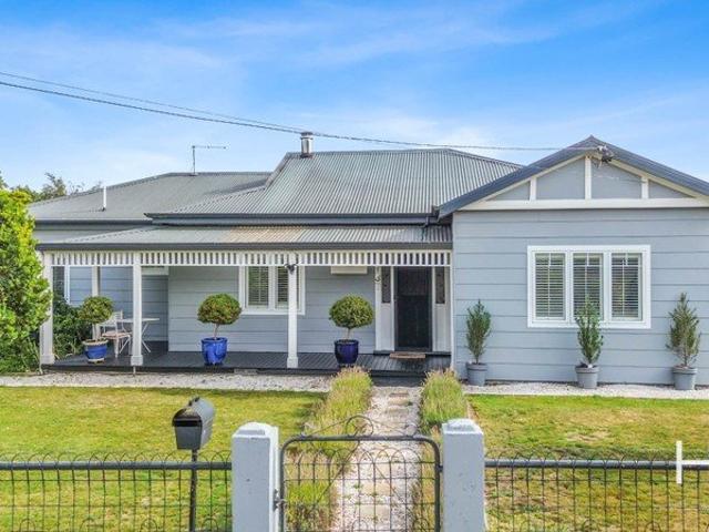 A Home Filled with Warmth, Character & Opportunity!