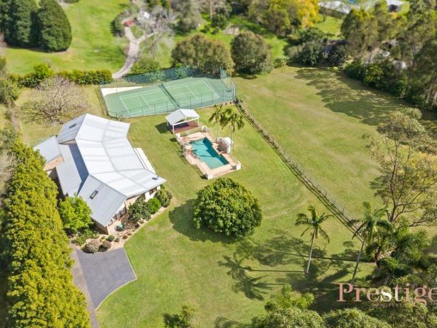 A Private Acreage Retreat with Pool, Tennis Court and Exceptional Family Living