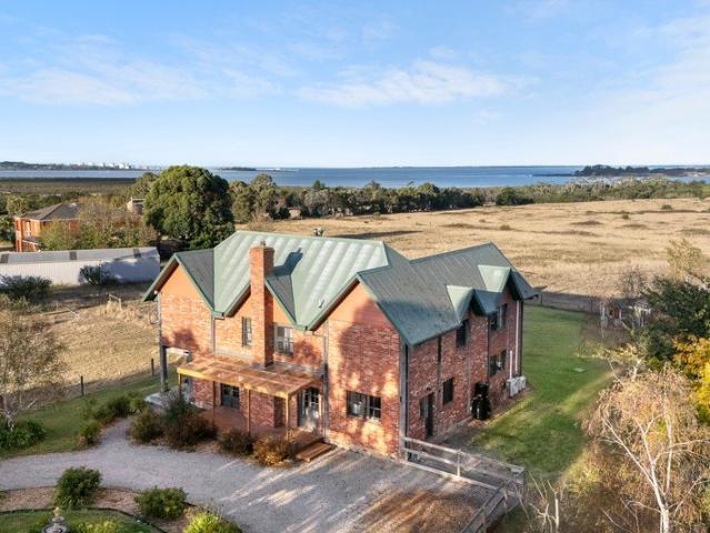 Elevated Acreage Living with Unrivalled Bay Views