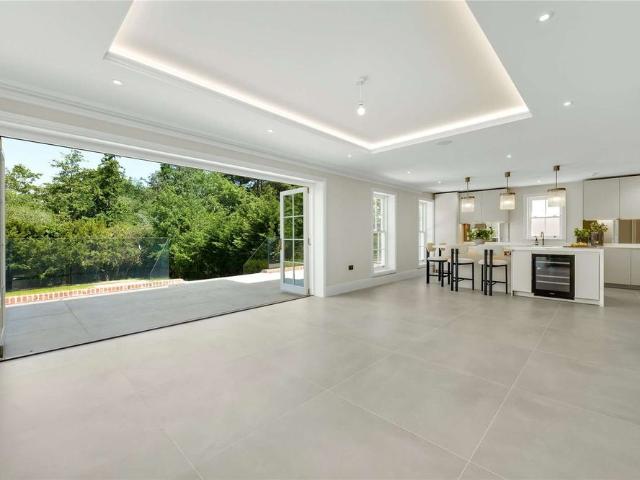 A striking and exceptionally spacious newly built residence in the sought after Esher Place private estate