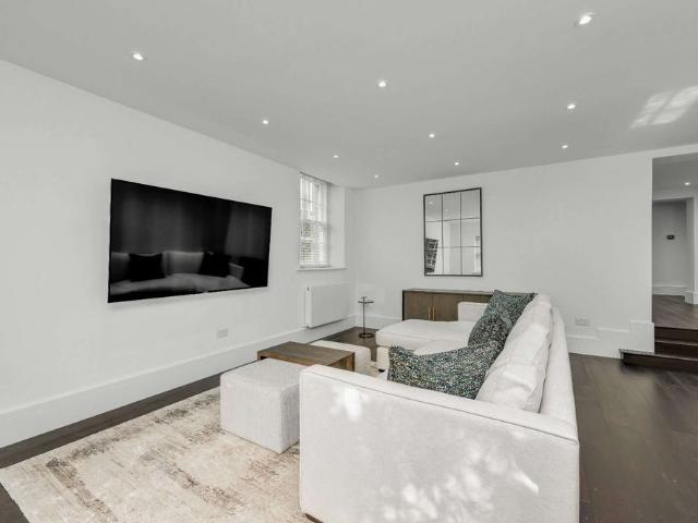 A stylish, newly refurbished three bedroom ground floor apartment with a private patio in the heart of Esher