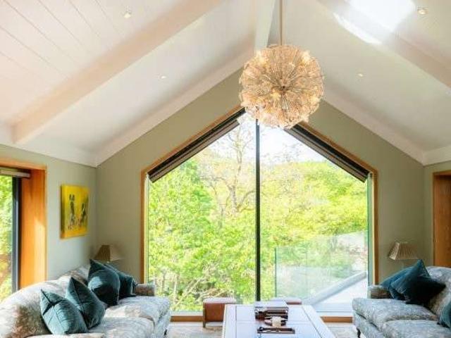 A substantial and beautifully presented four bedroom house, set in an elevated position with valley views. Driveway, large garage workshop with a lift to the li