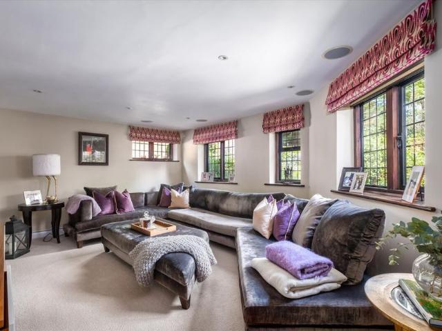 A superb countryside home with spectacular views, a tennis court, swimming pool, putting green & stables situated close to Guildford Town, available to let