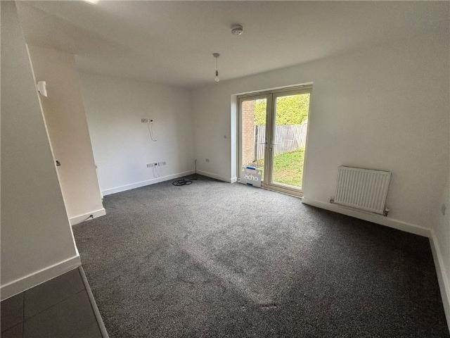 A spacious three bedroom mid terraced family home, benefiting from an allocated parking space and a private rear garden