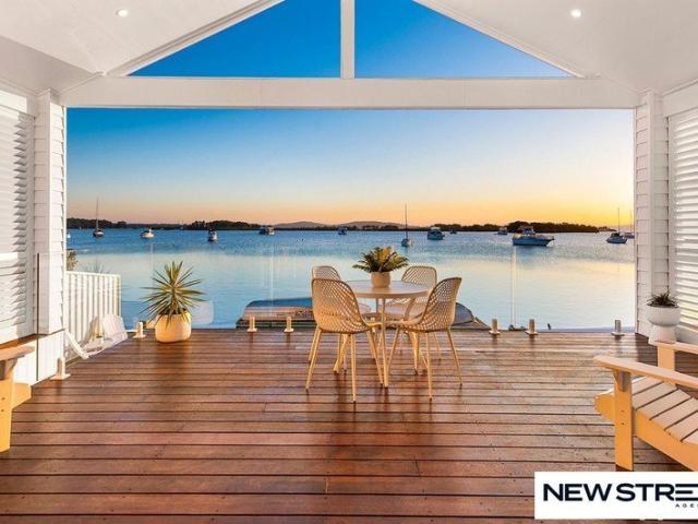 A Waterfront Sanctuary of Style, Serenity & Uninterrupted Lake Living