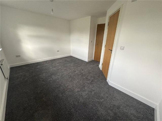 A well presented four bedroom terraced house offering spacious accommodation over three floors with a private rear garden, garage and allocated parking