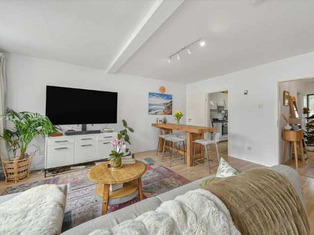 A well presented three bedroom townhouse with private parking and a garage