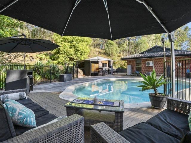 Acreage Oasis with Ultimate Shed Storage & Dual living potential
