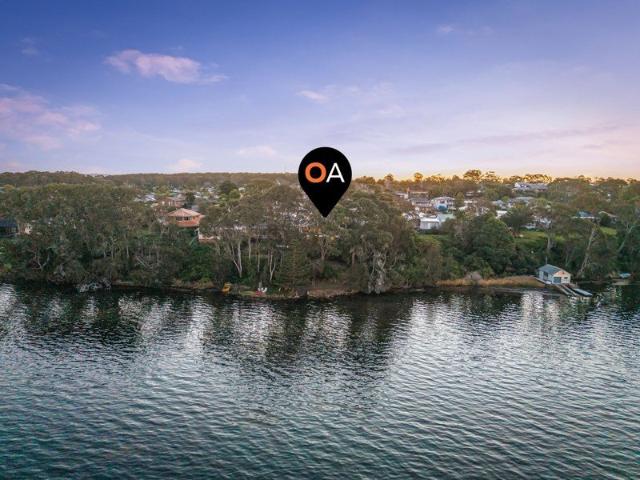 Absolute waterfront four bedroom home with private boat ramp