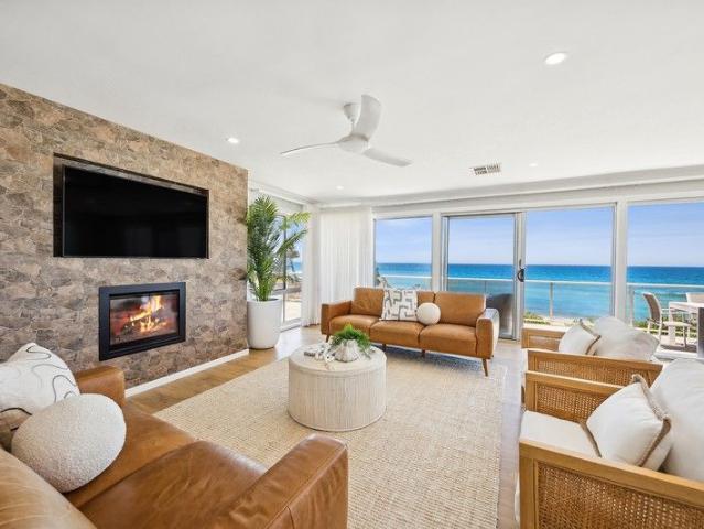 Absolute beachfront home on an elevated parcel