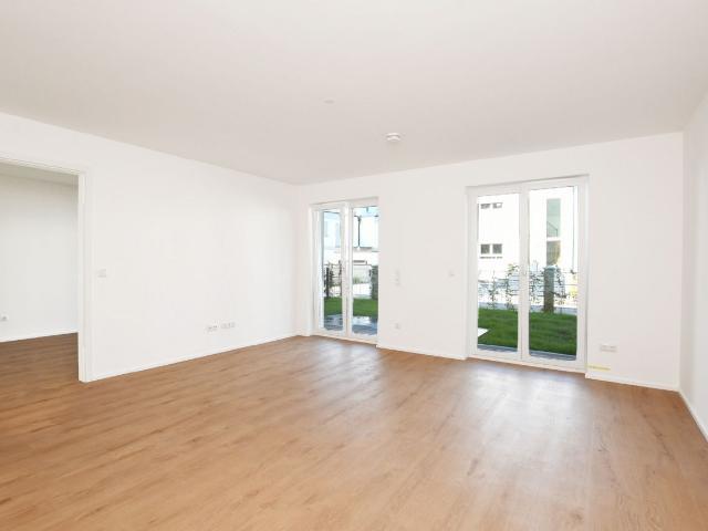 AIGNER Neubau Erstbezug: 3 Zimmer Erdgeschosswohnung mit Hobbyraum und Garten!