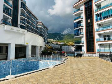 Alanya Cikcilli’de Deniz Ve Dağ Manzaralı Prestijli Sitede 1+1 Satılık Daire