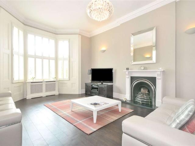 An elegant Victorian house with a spacious garden