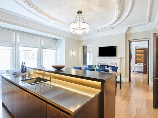 An exceptional three bedroom, north west facing, lateral apartment set within a Victorian red brick, Grade II listed building in the heart of Mayfair