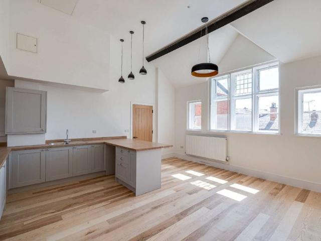 An exceptional three bedroom duplex apartment showcasing dramatic volume and architectural character