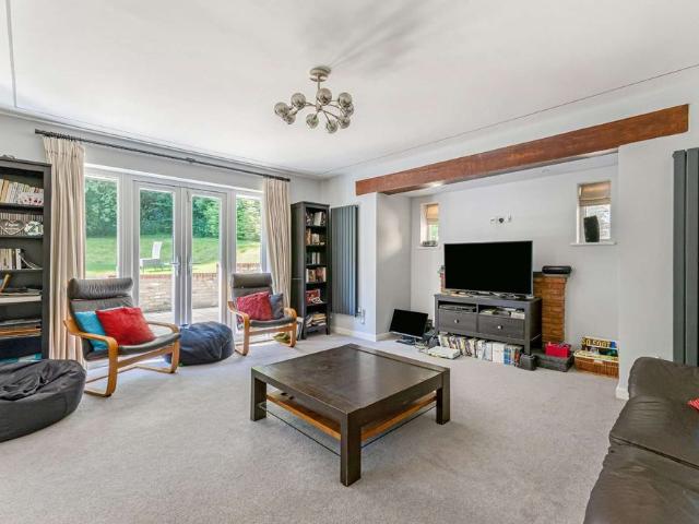 An exceptional detached home which has been substantially extended and comprehensively refurbished to create a beautifully appointed family home, set within mature private grounds