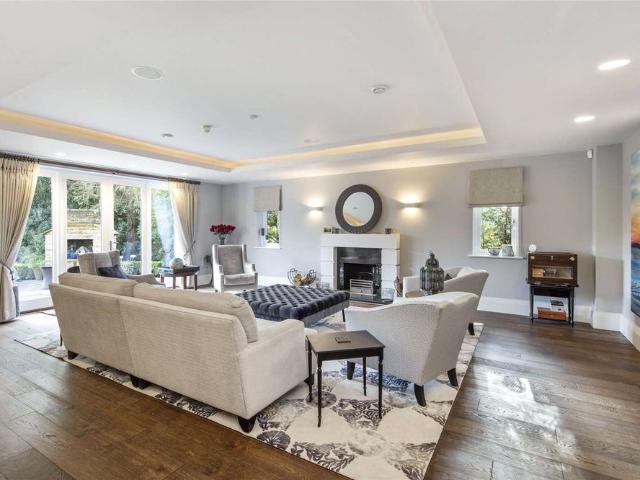 An exceptional five bedroom home with cinema room & gym, set within a garden of approximately 0.4 acres and located within the prestigious Oxshott Way Estate