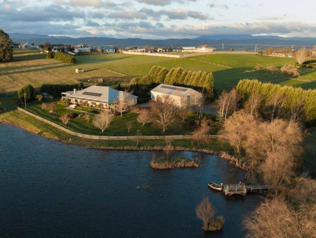 An idyllic Tasmanian country escape 4ha Riverside property with private lake, established vineyard and exceptional 10 car garage with rumpus room