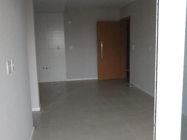 apartamento central novo com garagem um dormitorio