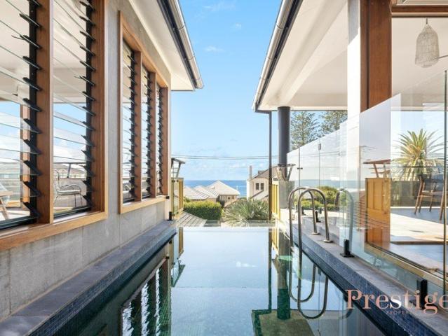 Architectural Coastal Luxury with Ocean Views, Moments from Blue Bay Beach