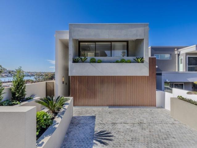 Architectural Waterfront Masterpiece with Designer Finishes