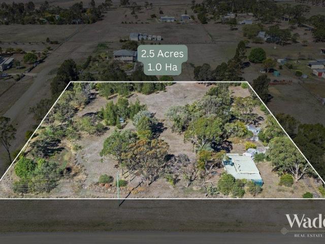 Are you ready to roll up your sleeves and transform this extraordinary 2.5 acre residential corner block, complete with established trees and a dam?