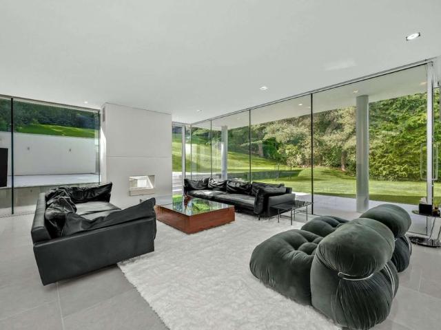 Award winning contemporary home with five en suite bedrooms, landscaped gardens, a swimming pool and triple garage