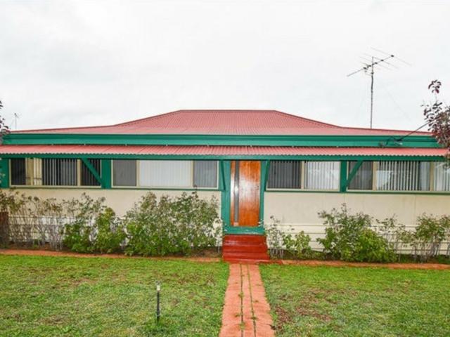 Beautifully maintained cottage home with drive through access and parking