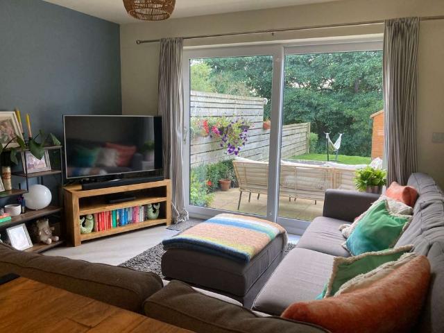 Beautifully presented, fully furnished three bedroom townhouse enjoying a south facing garden, peaceful streamside outlook, in sought after village location with superb local amenities