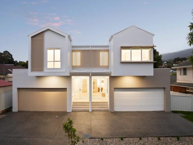 New designer duplex with rare side yard access & double garage
