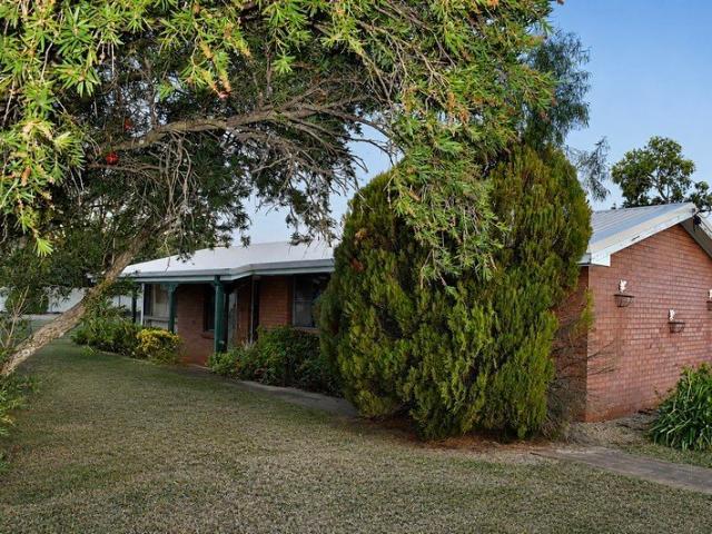 Brick Family Home with Media Room, Large Yard and Peaceful Town Living
