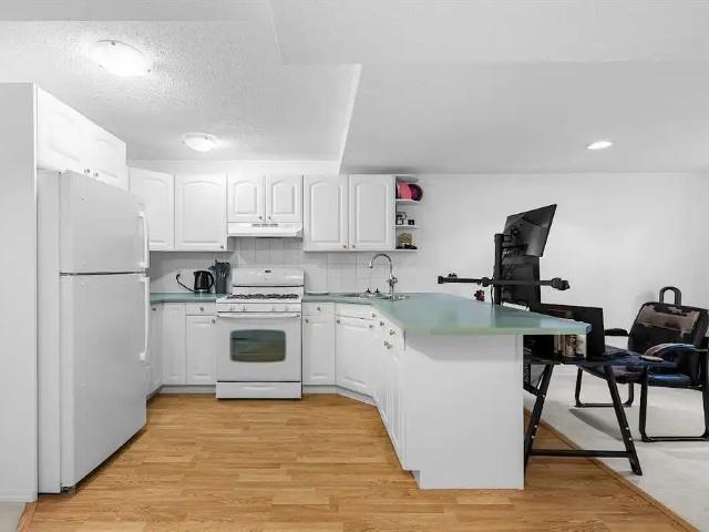 Bright 1 Bedroom + Den Basement in Killarney with Parking, A/C & Laundry